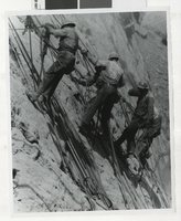 Photograph of dam workers scaling wall of Black Canyon, Hoover Dam,1933