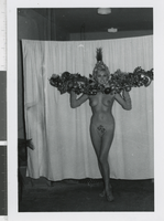 Photograph of showgirl posing with a headdress, Las Vegas (Nev.), 1957-1960s