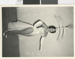 Photograph of a showgirl posing with a headdress, Las Vegas (Nev.), 1957-1960s