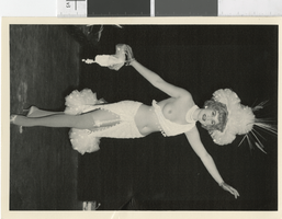 Photograph of topless showgirl with headdress posing onstage, Las Vegas (Nev.), 1957-1960s