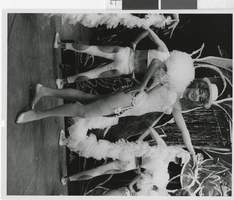 Photograph of costumed showgirl and male dancers onstage, Las Vegas (Nev.), 1957-1960s