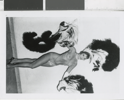 Photograph of showgirl with headdress posing backstage, Las Vegas (Nev.), 1957-1960s