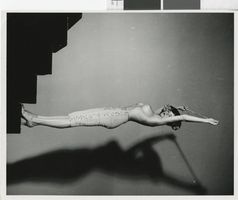 Photograph of topless showgirl posing on a staircase, Las Vegas (Nev.), 1957-1960s
