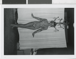 Photograph of a topless showgirl wearing a chandelier headdress, Dunes Hotel, Las Vegas (Nev.), 1957-1960s