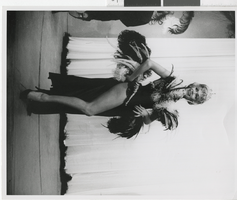 Photograph of a showgirl posing in a feathered costume, Dunes Hotel, Las Vegas (Nev.), 1957-1960s