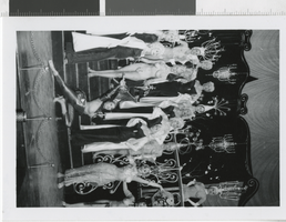 Photograph of topless and costumed showgirls with chandelier headdresses, Dunes Hotel, Las Vegas (Nev.), 1957-1960s