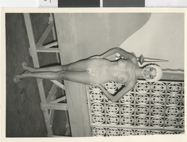 Photograph of a topless showgirl posing backstage, Dunes Hotel, Las Vegas (Nev.), 1957-1960s