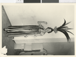 Photograph of a showgirl posing backstage wearing a fringed costume, Dunes Hotel, Las Vegas (Nev.), 1957-1960s