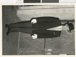 Photograph of a male performer posing backstage wearing a suit, Dunes Hotel, Las Vegas (Nev.), 1957-1960s