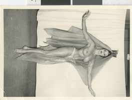Photograph of a topless showgirl posing in a harem costume, Dunes Hotel, Las Vegas (Nev.), 1957-1960s