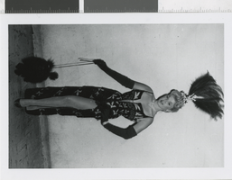 Photograph of a showgirl posing with a dog, Las Vegas (Nev.), 1957-1960s