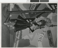 Photograph of a showgirl posing in a Parisian costume, Las Vegas (Nev.), 1957-1960s