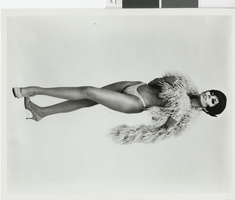 Photograph of a showgirl wearing a feather boa, Las Vegas (Nev.), 1957-1960s