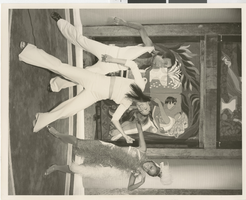 Photograph of three Minsky's Burlesque cast members in front of a painted wooden set piece, Playboy Hotel, Chicago (Ill.), circa 1977