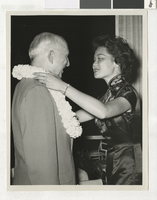 Photograph of C. D. Baker receiving a lei from a woman, 1960-1972