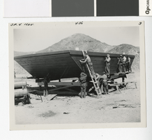Photograph of men working on a scow, Lake Mead, 1935-1940