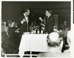 Photograph of Dean Martin and Frank Sinatra performing onstage at the Copa Room in the Sands Hotel, Las Vegas, January 22, 1964