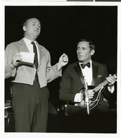 Photograph of Joey Bishop playing the mandolin at the Sands Hotel, Las Vegas, August 1965