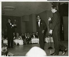 Photograph of Dean Martin, Sammy Davis, Jr. and Frank Sinatra performing together at the Copa Room, Las Vegas, circa 1950s to 1960s