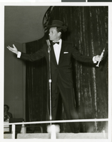 Photograph of Joey Bishop in a top hat at the Copa Room, Las Vegas, circa 1960s