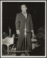 Phil Foster singing on stage: photographs