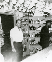 Photograph of "Bill" at the inside bar of Gilbert's Liquor Store