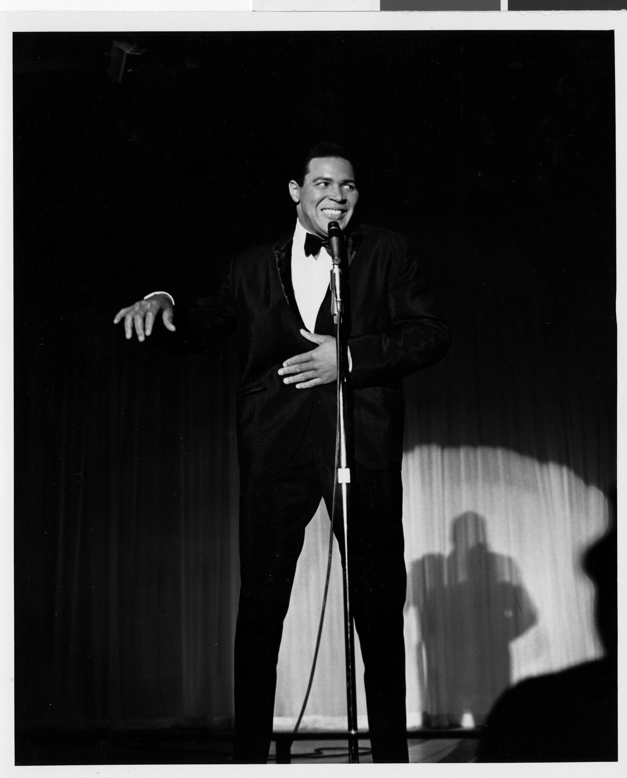 Photograph of Chubby Checker performing onstage at the Sands Hotel, August 1962