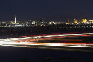Headlights streak as cars drive on 215 the Beltway at night, Las Vegas, Nevada: digital photograph