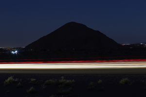 Headlights streak as cars drive on 215 the Beltway at night, Las Vegas, Nevada: digital photograph