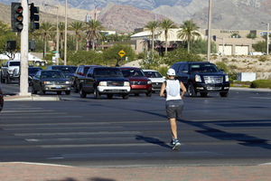 Jogger crossing South Town Center Diver at West Sahara Avenue, Las Vegas, Nevada: digital photograph