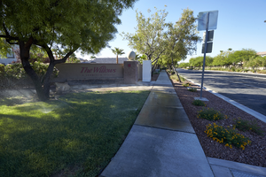 Sprinklers watering grass in common area of the Summerlin village of The Willows, Las Vegas, Nevada: digital photograph