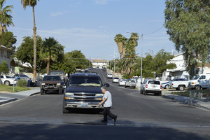 Pedestrain walks in front of a car on West Alcoa Avenue at Richfield Boulevard looking west, Las Vegas, Nevada: digital photograph