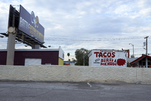 Billboard over businesses on West Sahara Avenue looking south, Las Vegas, Nevada: digital photograph