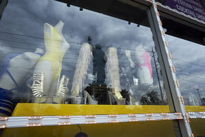 Statue of Liberty replica on West Sahara Avenue east of South Arville Street reflected in business window, Las Vegas, Nevada: digital photograph