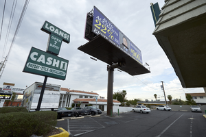 Billboard in parking lot on West Sahara Avenue near Rye Street, looking east, Las Vegas, Nevada: digital photograph