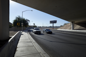 Traffic flows under the freeway overpass at East Sahara Avenue and Sandhill Road looking east, Las Vegas, Nevada: digital photograph