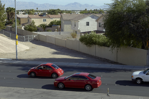 Traffic flows on next to a neighborhood that bounds the freeway overpass on East Sahara Avenue near Sandhill Road looking north, Las Vegas, Nevada: digital photograph