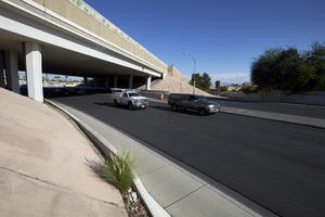 Traffic flows under the freeway overpass at East Sahara Avenue and Sandhill Road looking west, Las Vegas, Nevada: digital photograph