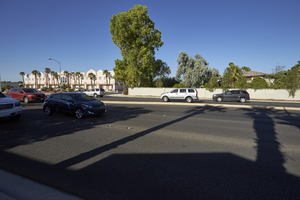 Traffic on Jones Boulevard near West Sahara Avenue with single family homes and commercial development, looking west, Las Vegas, Nevada: digital photograph