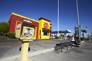 A news stand, bus stop and commercial development on Jones Boulevard, looking northwest, Las Vegas, Nevada: digital photograph
