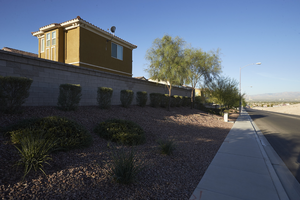Single family home with block wall, landscaping, and a sidewalk, looking west, Las Vegas, Nevada: digital photograph