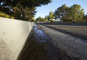 Water in gutter on Grand Canyon Drive north of Lake North Drive and south of West Sahara Avenue, looking north, Las Vegas, Nevada: digital photograph