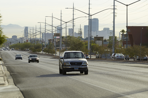 Cars on West Sahara Avenue east of Buffalo Drive with power lines and part of the Strip, looking east, Las Vegas, Nevada: digital photograph