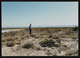 Phil Benson standing on the abandoned railroad bed of the Arden Plaster Company: photographic print