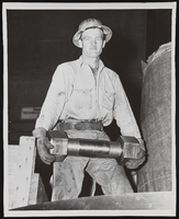 Unidentified man holding a stud bolt: photographic print