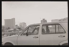 Unidentified person driving a car with casinos in the background: photographic print