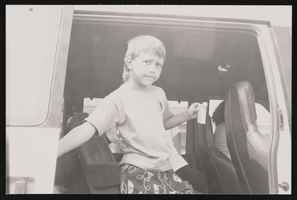 Unidentified child in the back of a van: photographic print