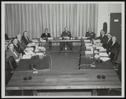 Howard Cannon posed in a conference room with others at the Air Force Ballistic Missile Headquarters, X-15 Test Facility in Los Angeles, California: photographic print
