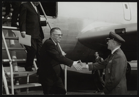 Air Force Ballistic Missile Headquarters, Howard Cannon and others in front of an airplane: photographic print