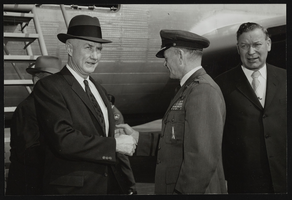 Air Force Ballistic Missile Headquarters, Howard Cannon and others in front of an airplane: photographic print